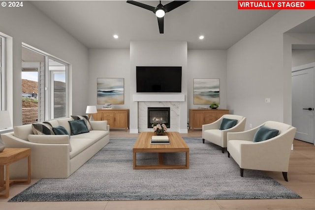 living room featuring light wood-type flooring and ceiling fan