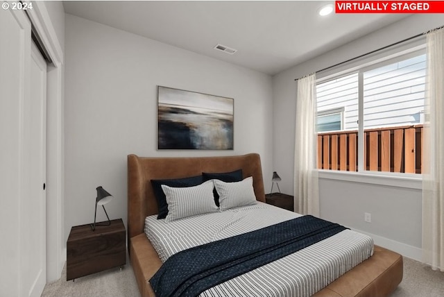 carpeted bedroom with a closet