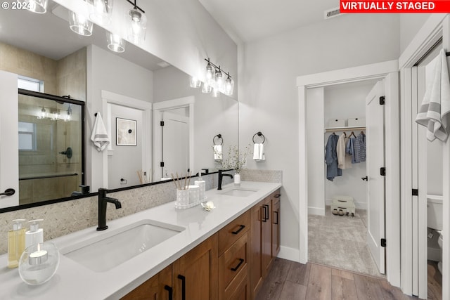 bathroom featuring vanity, hardwood / wood-style flooring, and an enclosed shower