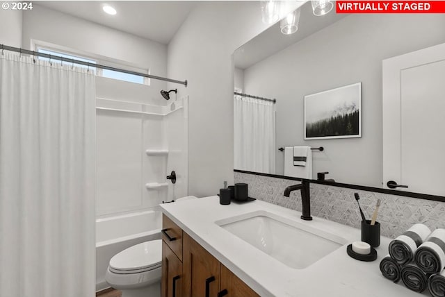 full bathroom featuring vanity, toilet, tasteful backsplash, and shower / tub combo with curtain