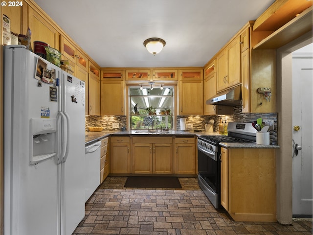 kitchen featuring backsplash, sink, and white appliances