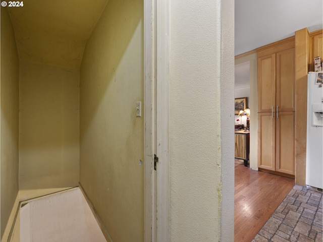 corridor with light hardwood / wood-style floors