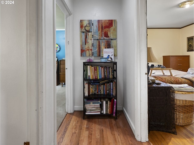 corridor with hardwood / wood-style flooring