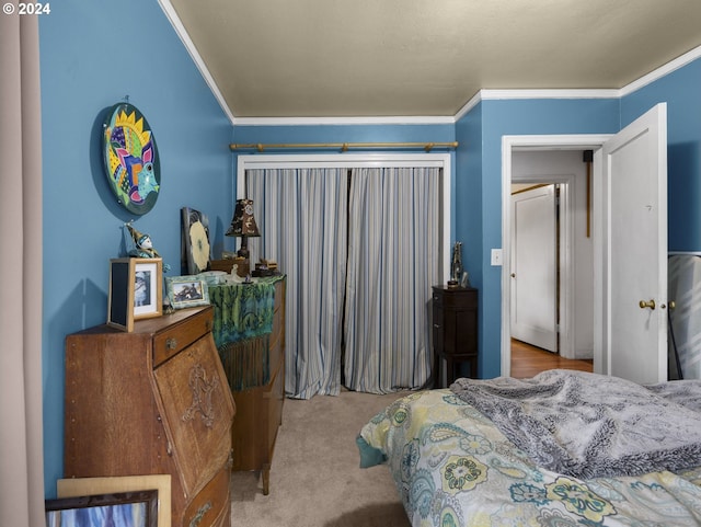 carpeted bedroom with ornamental molding