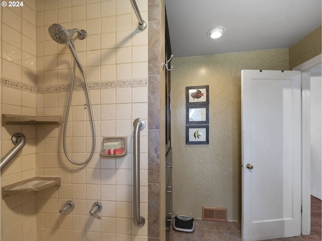 bathroom featuring tiled shower and hardwood / wood-style floors