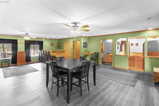 dining room featuring hardwood / wood-style flooring, ceiling fan, and ornamental molding