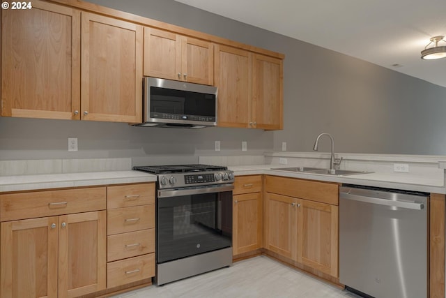 kitchen with sink, light brown cabinets, and appliances with stainless steel finishes