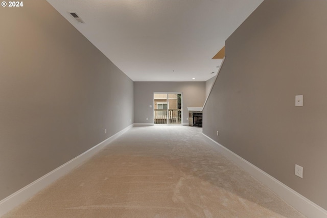 unfurnished living room featuring light carpet