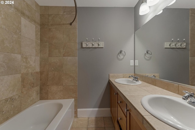 bathroom featuring tile patterned flooring, vanity, and tiled shower / bath combo