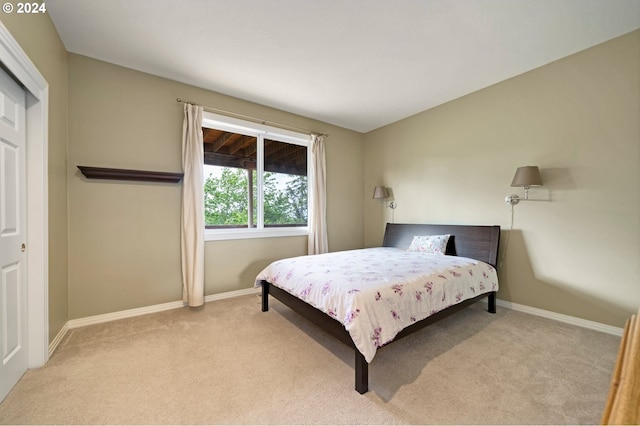 bedroom featuring light carpet