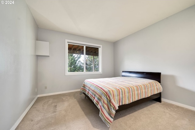 bedroom featuring light colored carpet