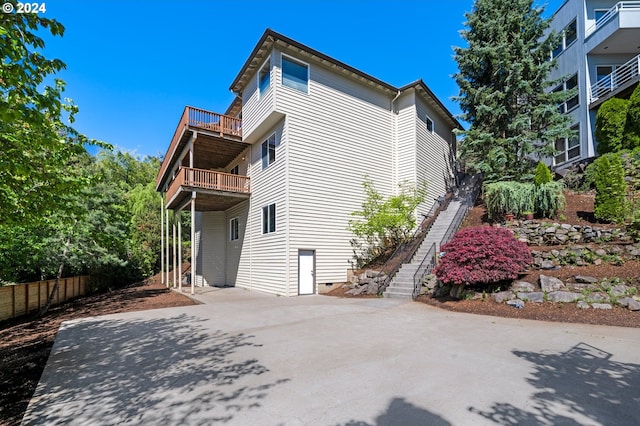 view of side of property with a balcony