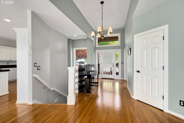 entryway featuring light wood-type flooring and a chandelier