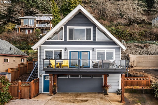 240 NE Williams Ave, Depoe Bay, OR 97341 - view of front facade featuring an attached garage, driveway, a balcony, and fence