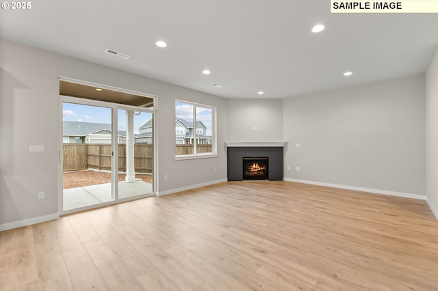 1376 NE Josephine Ct Unit 184, Estacada, OR 97023 - unfurnished living room with a fireplace, light wood-style floors, recessed lighting, and baseboards