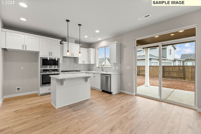 1376 NE Josephine Ct Unit 184, Estacada, OR 97023 - kitchen with light wood-style floors, appliances with stainless steel finishes, light countertops, white cabinets, and visible vents