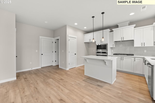 1376 NE Josephine Ct Unit 184, Estacada, OR 97023 - kitchen featuring decorative backsplash, light wood-style floors, visible vents, light countertops, and appliances with stainless steel finishes