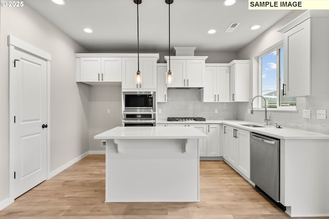 1376 NE Josephine Ct Unit 184, Estacada, OR 97023 - kitchen featuring white cabinetry, stainless steel appliances, decorative backsplash, and a sink