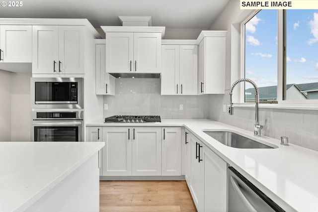 1376 NE Josephine Ct Unit 184, Estacada, OR 97023 - kitchen featuring white cabinets, stainless steel appliances, light countertops, and a sink