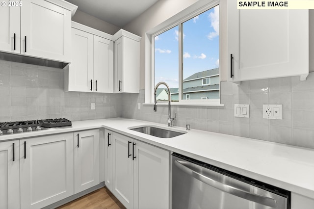 1376 NE Josephine Ct Unit 184, Estacada, OR 97023 - kitchen featuring decorative backsplash, white cabinets, a sink, stainless steel appliances, and light countertops