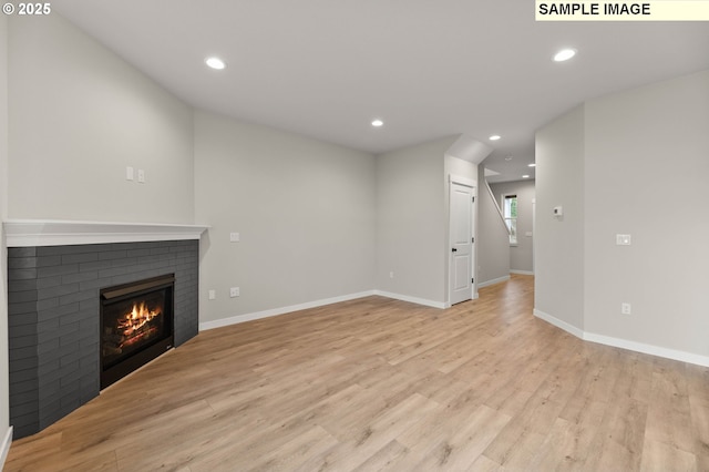 1376 NE Josephine Ct Unit 184, Estacada, OR 97023 - unfurnished living room with recessed lighting, light wood finished floors, baseboards, and a brick fireplace