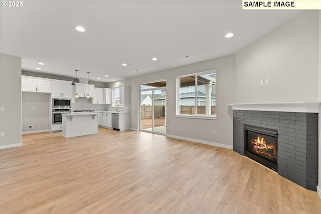 1376 NE Josephine Ct Unit 184, Estacada, OR 97023 - unfurnished living room with a fireplace, recessed lighting, and baseboards