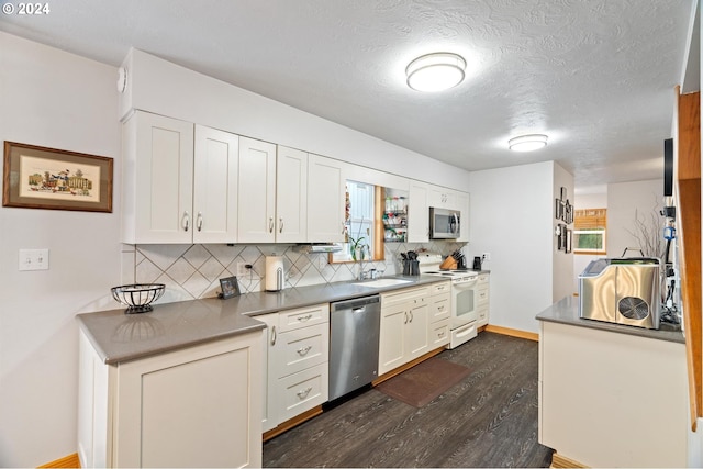 kitchen featuring appliances with stainless steel finishes, white cabinetry, and a healthy amount of sunlight