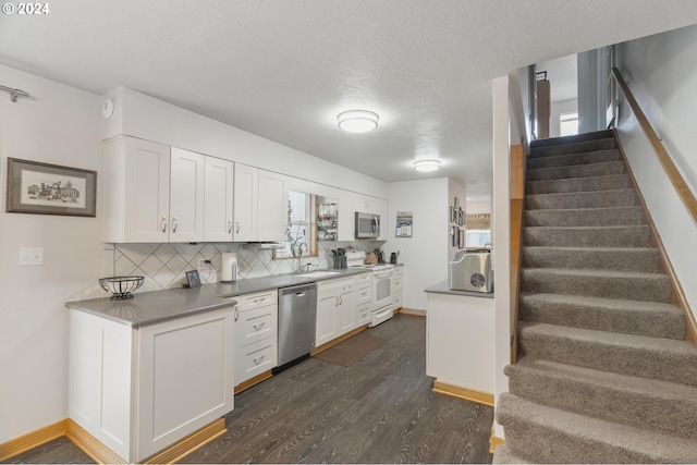 kitchen with appliances with stainless steel finishes, a textured ceiling, dark hardwood / wood-style floors, and white cabinets