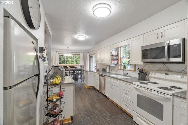 kitchen with white cabinetry, stainless steel appliances, and sink