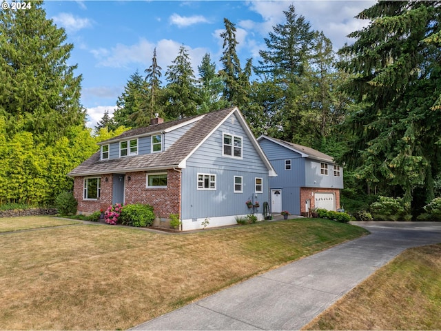 view of front of home with a garage and a front lawn