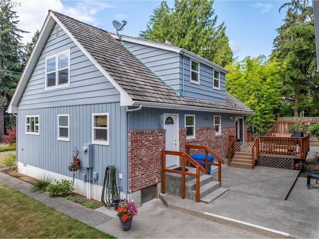 back of property with a patio area and a wooden deck