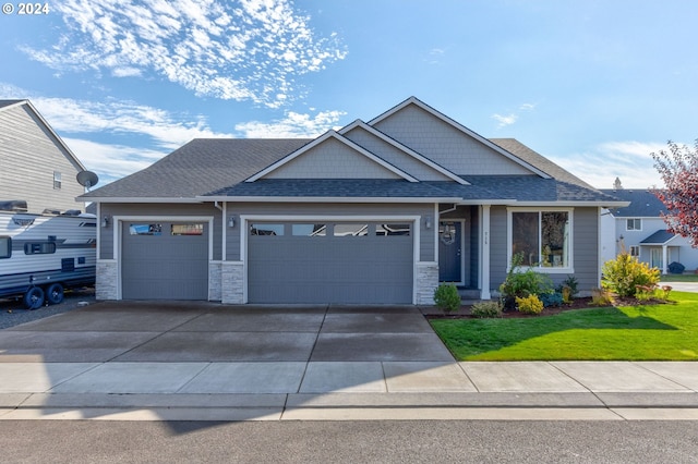 craftsman-style house featuring a front yard and a garage