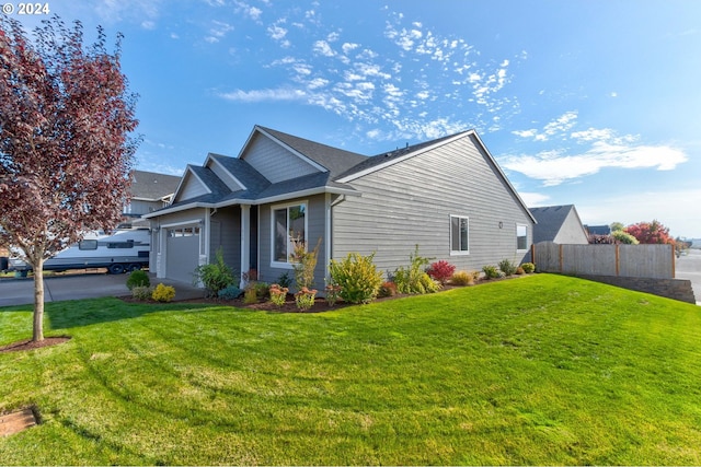 view of side of property with a lawn and a garage