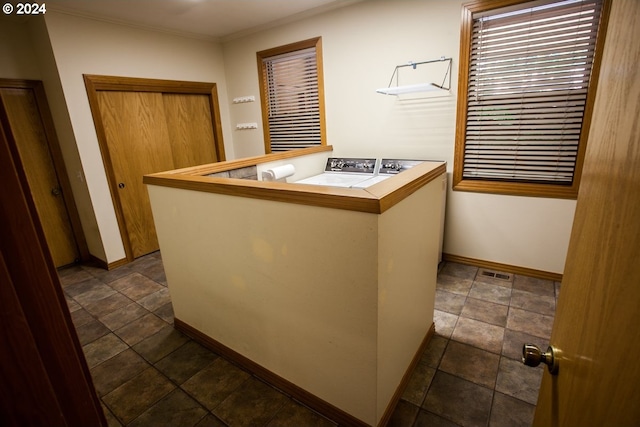 interior space featuring washer and dryer and ornamental molding