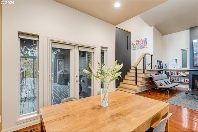 living room with light wood finished floors, baseboards, recessed lighting, and a high ceiling