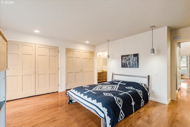 bathroom featuring hardwood / wood-style flooring, vanity, and recessed lighting