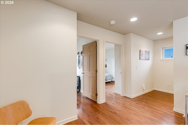 bedroom with light wood-type flooring, baseboards, recessed lighting, and a closet