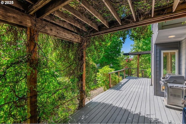 wooden deck featuring a grill
