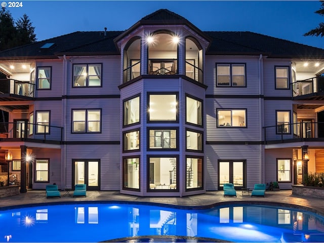 rear view of house with a balcony and a patio