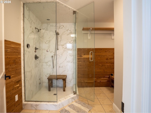 bathroom with wood walls, tile patterned flooring, and an enclosed shower