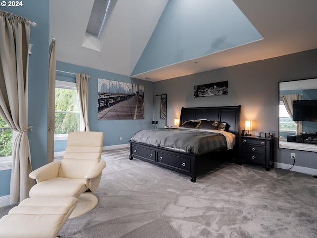 carpeted bedroom with high vaulted ceiling