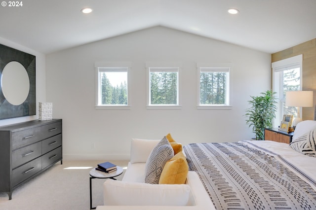 bedroom featuring lofted ceiling and light colored carpet