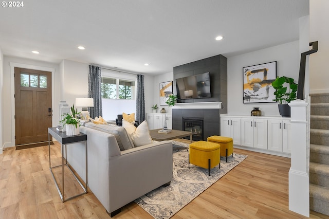 living room with light wood-type flooring and a fireplace