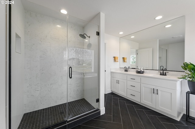 bathroom with walk in shower and vanity