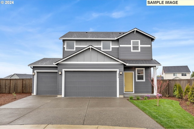 view of front of home with a garage and a front lawn