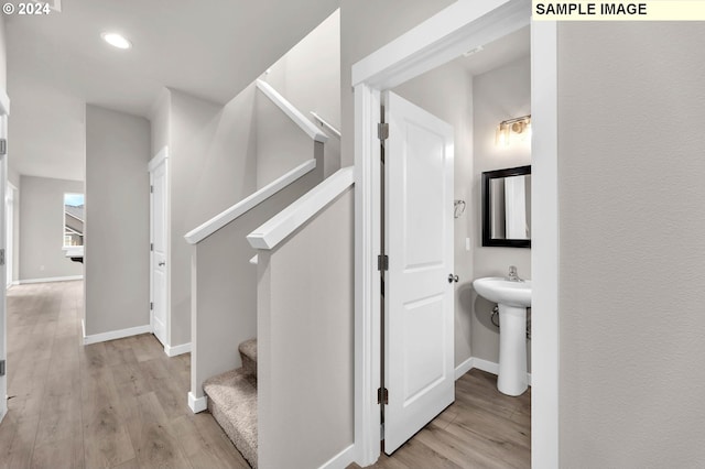 stairway with hardwood / wood-style floors