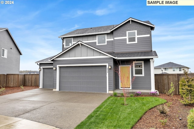 craftsman house featuring a front lawn and a garage