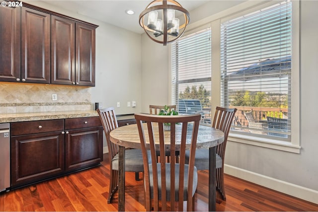 dining space featuring a notable chandelier and dark hardwood / wood-style floors