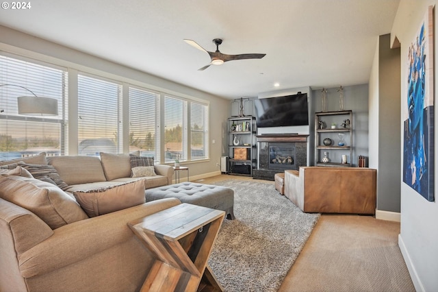 carpeted living room featuring ceiling fan