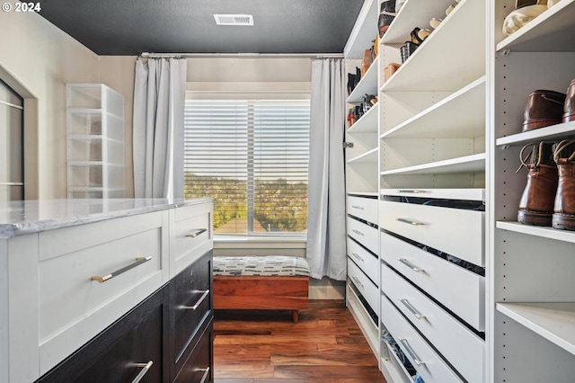 spacious closet with dark hardwood / wood-style floors